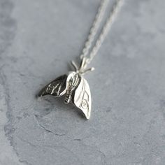 A tiny woodland moth, hand-carved and cast in sterling silver - a perfect gift for nature lovers. Moths are guided by the moon and fly fearlessly towards moonlight; wear this pendant as a symbol of your own bravery and self-belief. This delicate moth pendant hangs on an 18 inch fine silver chain. The pendant is small and delicate, dimensions are 14mm x 13mm. It can be worn alone or layered with other jewellery. Also available as a larger silver hawk moth necklace, as pictured: https://www.etsy.c