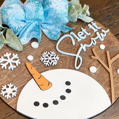 a wooden plate with a snowman on it