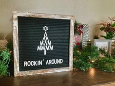 there is a sign that says rockin'around on the shelf next to christmas decorations