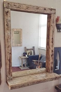 a mirror sitting on top of a wooden shelf