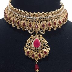 Heavy Bridal Sets For Festive Wedding, Heavy Bridal Sets For Wedding And Festive Occasions, Bollywood Chandbali Bridal Necklace For Marriage, Bollywood Style Chandbali Bridal Necklace For Marriage, Bollywood Style Heavy Wedding Jewelry, Traditional Red Bridal Sets For Formal Occasions, Heavy Red Wedding Sets, Diwali Ruby Jewelry Set With Intricate Design, Red Stone Work Sets For Gifts