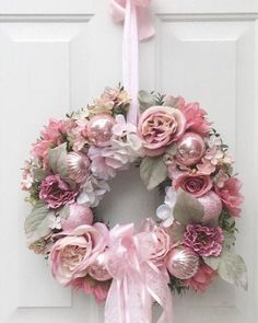 a pink wreath hanging on the front door