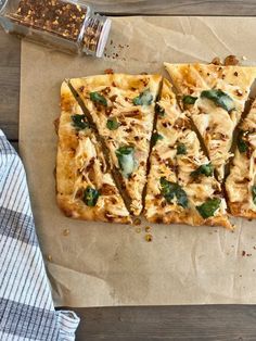 sliced pizza sitting on top of a piece of wax paper