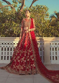 Designer Red Bridal Lehenga Dress for Indian Bridal Wear comes with choli that is fully hand worked with resham and pearls with heavy intricate motifs. Paired with a pure raw silk fused lengha with badla work jaal with heavy resham and till work borders. Comes with an organza mesori dupatta with resham aari jaal with 4 side borders of tilla work. Choli: Be one with defying fashion winds and become a trendsetter. The captivating combination of red and golden handwork on chiffon with heavy style w Red Raw Silk Gown For Navratri, Red Gown With Dori Work For Traditional Ceremonies, Red Raw Silk Lehenga For Traditional Ceremonies, Red Dola Silk Gown With Dupatta, Red Gown With Dupatta In Dola Silk, Red Gown With Resham Embroidery In Dola Silk, Red Dola Silk Gown With Resham Embroidery, Red Traditional Unstitched Gown, Festive Red Dola Silk Gown