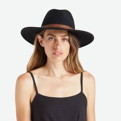 On a white background is a model wearing a black hat with a stiff brim and a brown leather strap around the base. Flat Brim Hat, Brim Hat, Velcro Straps, The Field, Wool Felt, Real Leather, Leather Straps, Genuine Leather, Felt