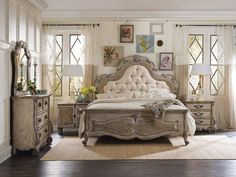 a large bedroom with white furniture and windows in the wall, along with hardwood floors