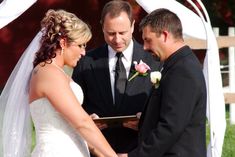 a bride and groom holding hands at their wedding ceremony