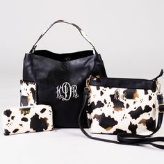 In love with adorable and summer fun cow print? We picked this set of bags just for you! The 'Wildest Dreams Cow Print Handbag' features two large exterior pockets, 11.5"h x 16"w, snap closure. The 'Wildest Dreams Crossbody Bag' measures 9"h x 10.5"w features an adjustable strap and interior pockets. The 'Wildest Dreams Cow Print Wallet' is only our most fierce wallet yet! When you pull this baby out of your bag, people will know you mean business! It measures 4"h x 8.5"w and features a zipper p Black Bag With Cow Print For Everyday Use, Trendy Cow Print Bags For Everyday Use, Rectangular Cow Print Travel Bag, Casual Everyday Bag With Cow Print, Casual Cow Print Bags For Daily Use, Embroidered Monogram, Wildest Dreams, Printed Handbags, Leather Products