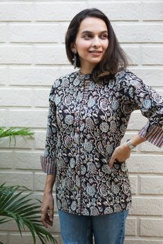 If you are looking for something light but professional, this shirt-style Kurti would be perfect for you. Made from 100% cotton, this Kurti lets you breathe, feels light and comfortable. And when it comes to the looks, the hand block print on black is just magic to the eyes. Elegant Blouse Designs, Western Tops, Printed Kurti, Elegant Shirt