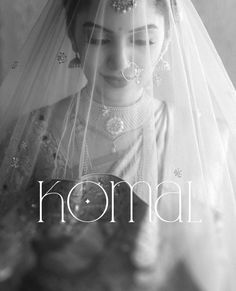 a black and white photo of a woman wearing a bridal veil with the word komal on it