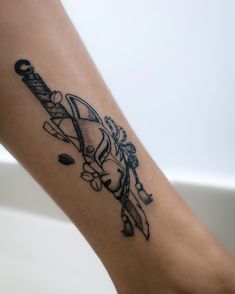 a woman's arm with a tattoo on it that has a knife and flowers