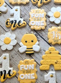 decorated cookies are arranged in the shape of flowers and bees with words that say it's fun to be one