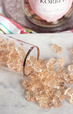 some small pieces of glass sitting on top of a table next to a bottle of wine