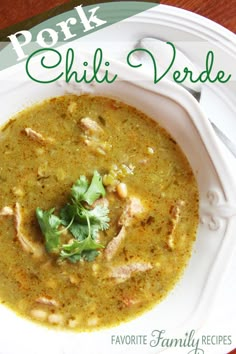 a white bowl filled with green soup and garnished with cilantro leaves