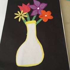 a painting of flowers in a vase on a black background with white paper and yellow border