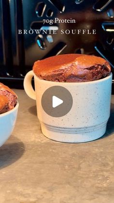 two mugs filled with brownies sitting on top of a counter