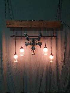 a light fixture with five lights hanging from it