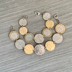 "Vintage French Coin Bracelet, Coin Jewelry,  France Souvenir, Silver Jewelry, Marianne Coin, Wanderlust, Statement Jewelry ---------------------------------------------------------------- Coin:  1 Franc, 2 Franc, 10 Franc, and 20 Centimes  Country: France Years: Various Have you traveled to France recently?  Celebrating your French heritage?  This bracelet made from pre-Euro French coins would make any lady a wonderful gift! Smaller sizes will be made with different denomination coins but similar design (see photo).  Also available as a charm bracelet if you prefer the coins to dangle from a chain rather than be linked together. These are authentic circulated coins prior to the Euro that have their own natural patina and markings. Looking for more French coin jewelry?  Check out my other Metal Coin Bracelets For Gift, Nickel-free Coin-shaped Bracelets As Gifts, Metal Coin Bracelets As Gifts, Penny Jewelry, Gold Coin Jewelry, French Heritage, Coin Jewellery, French Coins, Country France