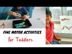 two children are sitting at a table and playing with magnets on the window sill