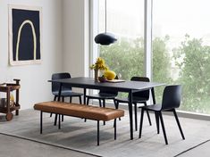 a dining room table with chairs and a bench