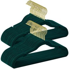 three pieces of green and gold metal with wavy lines on each side, in the shape of two spirals