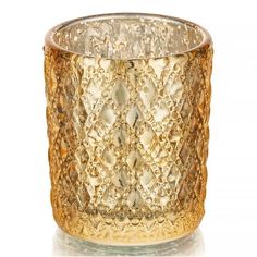 a gold colored glass candle holder on a white background