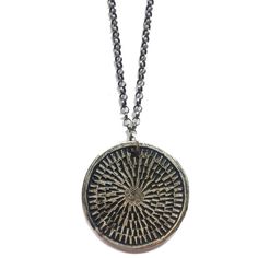 This unique and textural carved medallion is reversible to another carved pattern. It is reminiscent of a mandala. The meaning of mandala is Sanskrit for "circle." A mandala has a concentric structure, offering balancing visual elements. The purpose of a mandala is to serve as a tool to help harmonize and bring about unity, to absorb the mind so that the chatter stills and higher consciousness can be reached. Made of sterling silver on an oxidized, adjustable 16-18" sterling chain. Symbolic Brass Medallion Necklace, Bronze Etched Medallion Jewelry, Etched Medallion Amulet Necklace, Artisan Stamped Medallion Jewelry, Amulet Style Medallion Necklace With Large Pendant, Artisan Medallion Necklaces With Oxidized Finish, Artisan Style Medallion Necklaces With Oxidized Finish, Artisan Medallion Necklace With Oxidized Finish, Stamped Medallion Amulet Jewelry