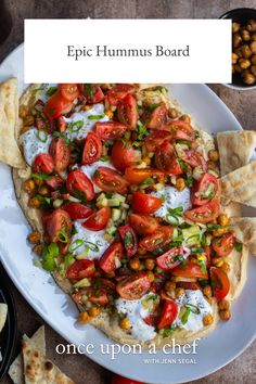 a white plate topped with a pizza covered in lots of veggies