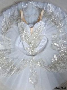 a white ball gown with silver sequins on the bouncy and back