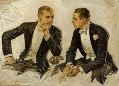 two men in tuxedos are sitting down