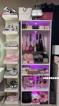 a closet filled with lots of different types of shoes and purses on shelves next to a desk