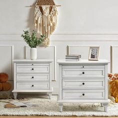 two white dressers sitting next to each other on top of a carpeted floor