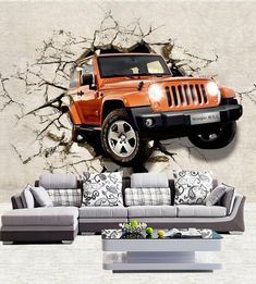 an orange jeep is breaking through the wall in this living room with grey couches