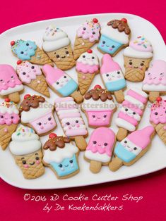 a white plate topped with lots of decorated cookies