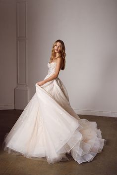 a woman in a wedding dress posing for the camera