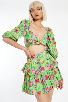 A bright and colorful crop top to give you a playful boho look. This green floral blouse features beautiful flowers that burst in every color of the rainbow. This top is fun and makes resort wear interesting! Perfect to wear with flats or sandals, A must-have item for summer vacations and cookouts! Matching top skirt separately. Matching Top And Skirt, Green Floral Blouse, Green Mini Skirt, Ruffle Design, Colorful Crop Tops, Size 10 Models, Ruffle Mini Skirt, Puff Sleeve Crop Top, Summer Vacations