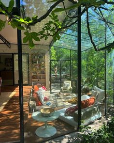 a living room filled with furniture under a glass roof