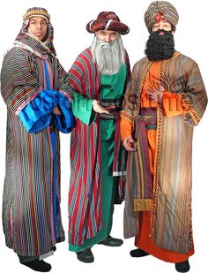 three men dressed in colorful clothing standing next to each other with long hair and beards