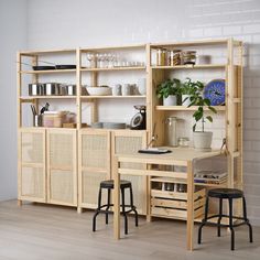 a room with some shelves and stools near a plant on the table in front of it