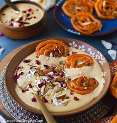 some food is sitting in a bowl on a table with other plates and utensils