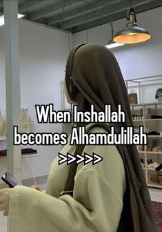 a woman in a hijab holding a cell phone with the caption when inshallah becomes alhamdullah