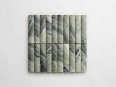 four pieces of marble are arranged in the shape of rectangles on a white wall