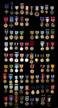 many medals are displayed on a black background