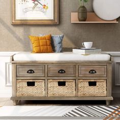 a bench with baskets on it in front of a painting and coffee table next to other items