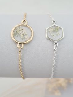 Pretty and dainty bracelet featuring real pressed Queen Anne's Lace.  Tiny off white flowers tiny set in resin. The flower is set in round gold plated setting measuring 22mm in diameter or silver plated hexagonal setting (including the loops for the chain). This bracelet will arrive in a bag ready for giving. Adjustable Round Bracelets With Pressed Flowers, Adjustable Bracelets With Pressed Flowers, Delicate Birth Flower Bracelet, Delicate Adjustable Jewelry With Pressed Flowers, Adjustable Flower Bracelets With Pressed Flowers, Adjustable Birth Flower Bracelet For Wedding, Bridesmaid Bracelet Flower, Resin Flower Jewelry, Young Enterprise