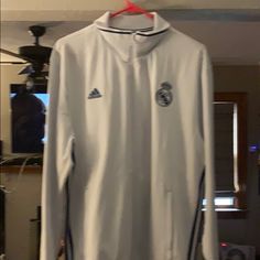 Brand New Adidas Real Madrid Soccer Club Warm-Up Jacket White With Blue Stripes No Stains No Rips No Tears With Tags Adidas White Winter Track Jacket, Adidas White Track Jacket For Winter, White Adidas Track Jacket For Winter, White Sports Tops With Pockets, White Long Sleeve Casual Track Jacket, White Adidas Outerwear With Pockets, White Long Sleeve Sports Outerwear, Adidas Long Sleeve Track Jacket With Pockets, Hoodie Jacket Men