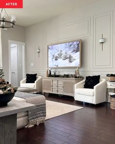 a living room filled with furniture and a painting on the wall above it's fireplace