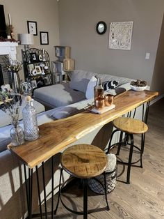 a living room filled with furniture next to a fire place and a wooden counter top