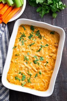 a casserole dish with carrots and celery