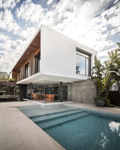 a large swimming pool next to a modern house